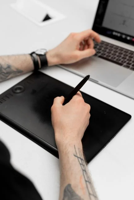 Hands browsing sneakers on laptop, showcasing online store shopping experience.
